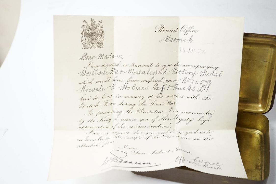 A posthumous First World War medal trio awarded to PTE. R. Holmes Oxf. & Bucks. L.I., together with the issuing letter, the remains of the original card box and a Princess Mary Christmas tin. Condition - fair.